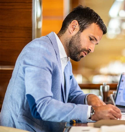 african american couple sitting on couch reading documents